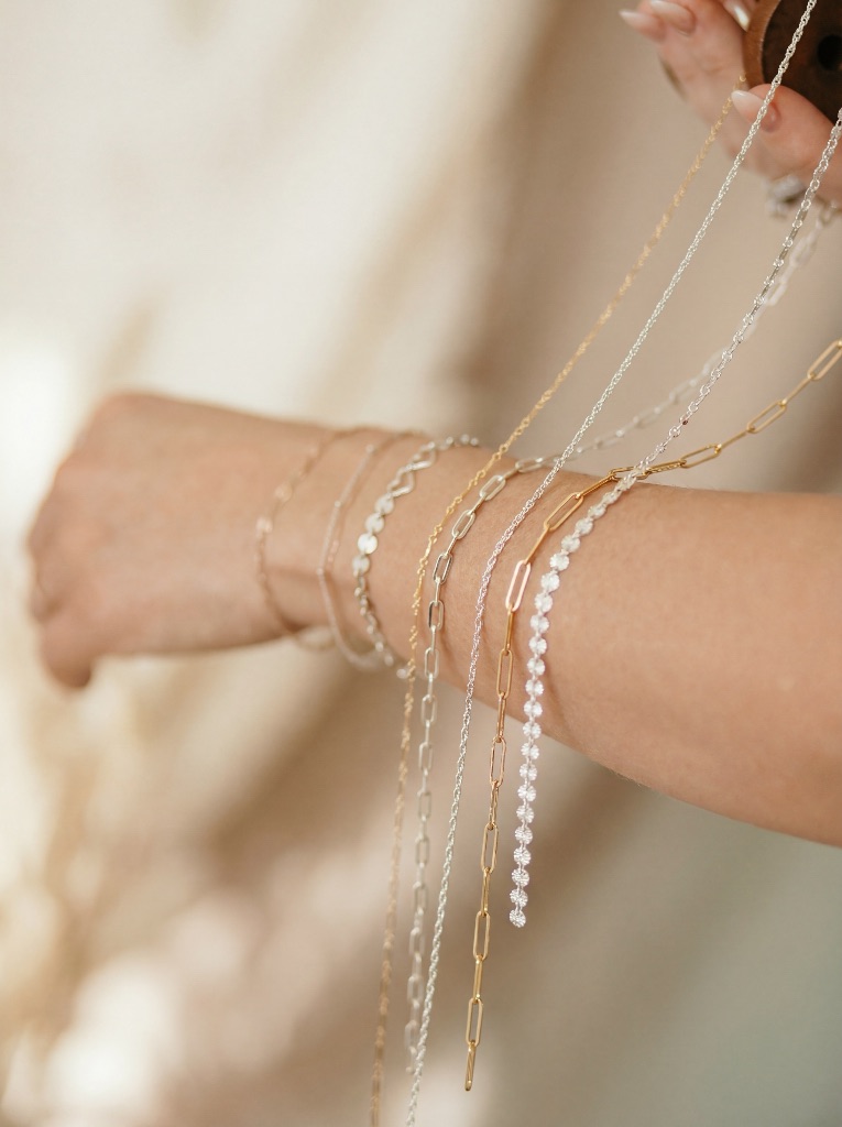 Cascading permanent bracelets - gold and silver chains flowing from wrist